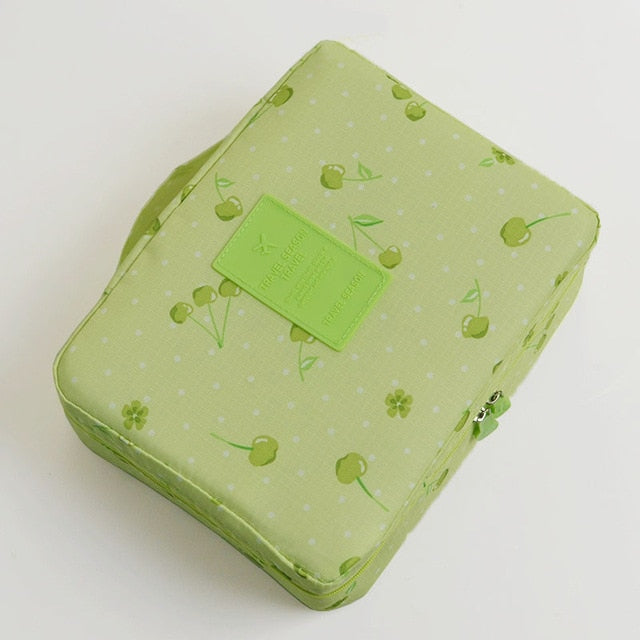 Waterproof beauty organizer, dark blue floral, perfect for women's travel.