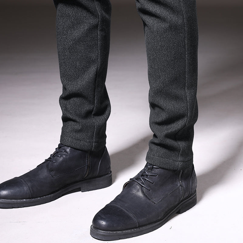 Men's dark gray slim fit trousers paired with a shirt, demonstrating versatile work-to-casual style.