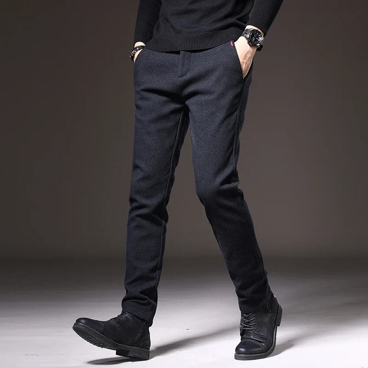Close-up of black men's stretch trouser fabric, highlighting comfortable slim fit design.