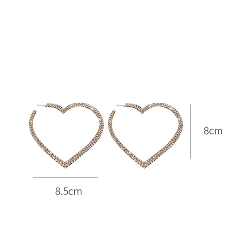 Close-up of large crystal heart earrings, showcasing brilliant sparkle & intricate design. Dazzling statement jewelry.
