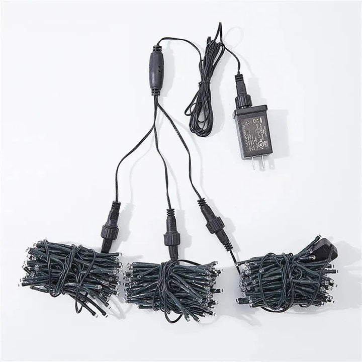 Dynamic LED meteor shower lights with chasing effect, enhancing garden trees for festive outdoor ambiance.
