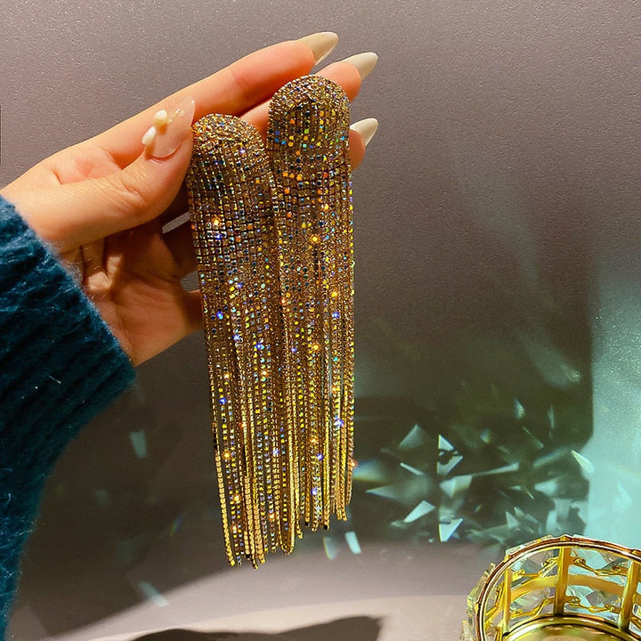 Close-up of sparkling rhinestone tassel drop earrings. Elegant women's jewelry, ideal for parties & weddings.