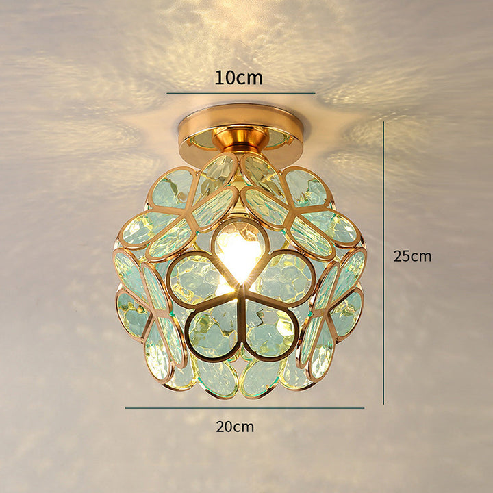 Intricate flower pattern on a decorative glass ceiling lamp, showcasing artistic detail for home decor.