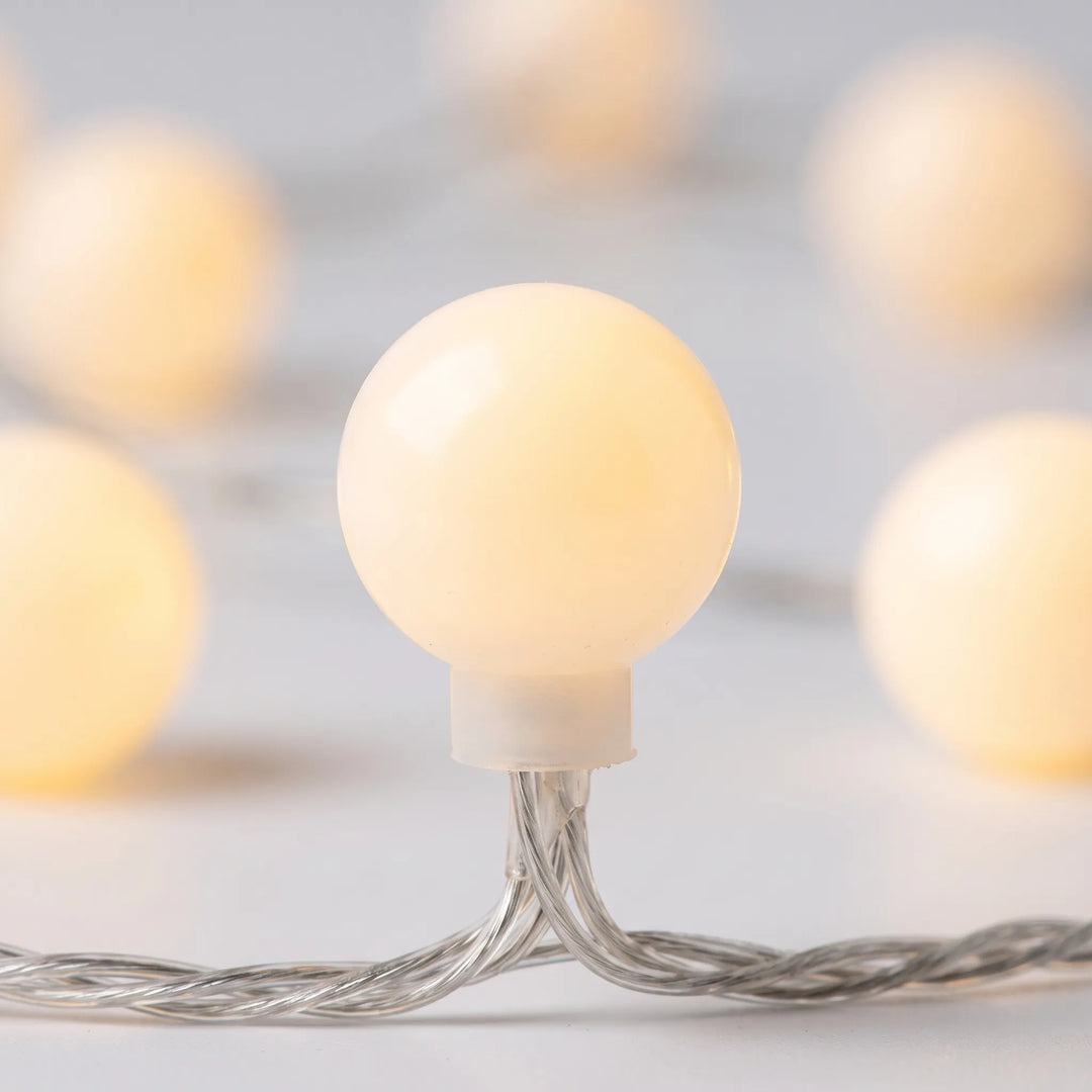Elegant LED globe string lights for outdoor patio & garden decor. Weather-resistant fairy lights enhance ambient lighting.