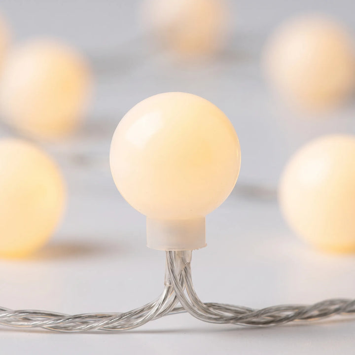 Elegant LED globe string lights for outdoor patio & garden decor. Weather-resistant fairy lights enhance ambient lighting.