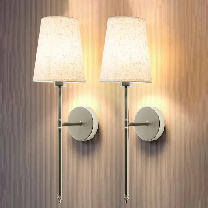 Elegant fabric wall sconce set (2) provides soft ambient light. Wireless & battery-operated for versatile home decor.