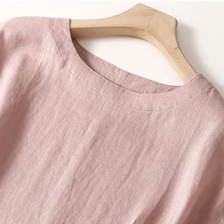 Flattering Women's Elara Dress in a vibrant pink, showcasing its elegant flowing skirt & stylish cinched waist.