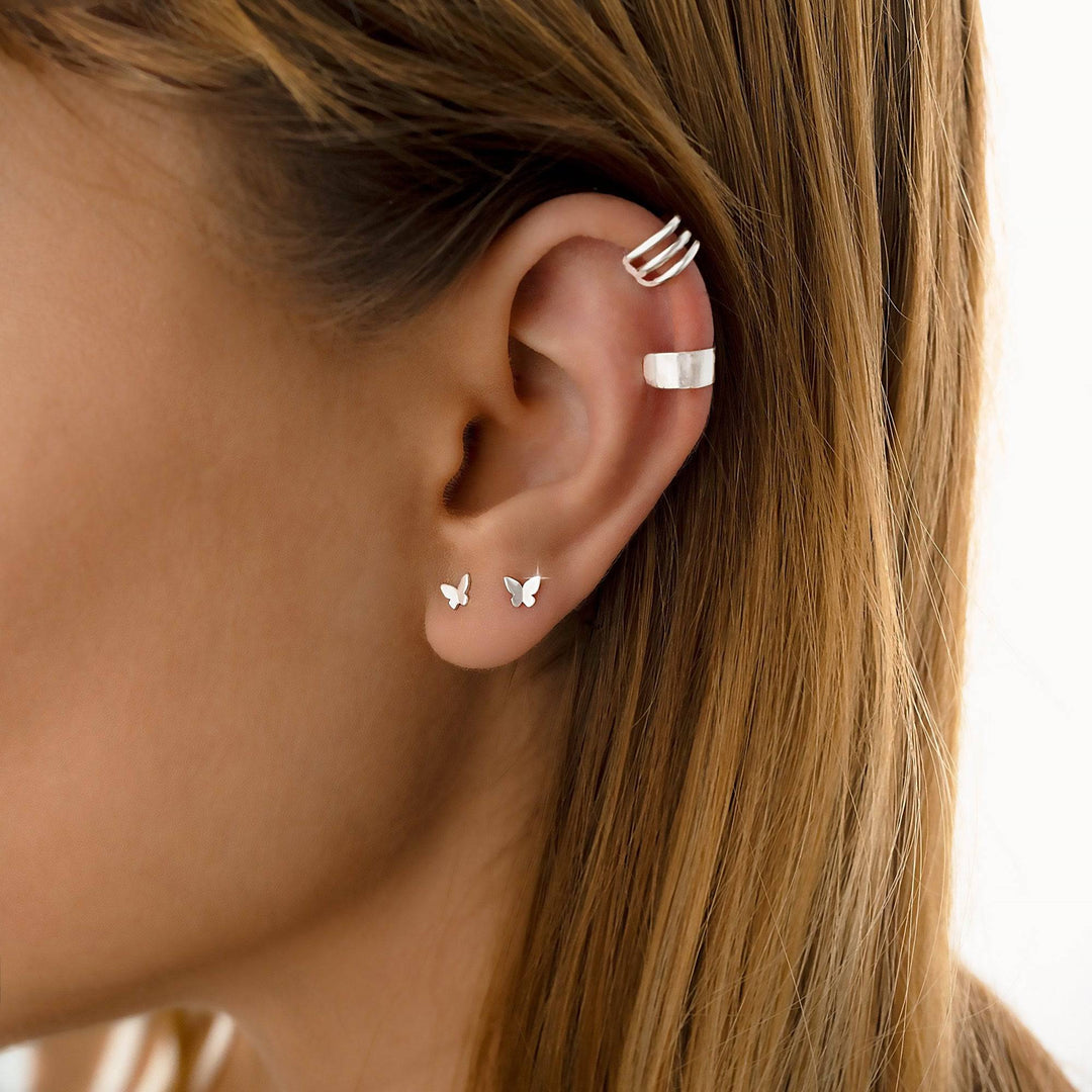 Elena mini butterfly stud earrings in sterling silver, a delicate and charming everyday accessory.