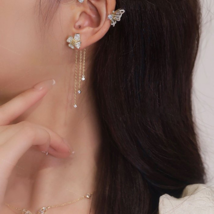 Model wearing delicate silver butterfly drop earrings, showcasing elegance and style