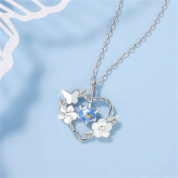 Women's elegant silver necklace with a beautiful seashell flower heart pendant, ideal ocean-inspired gift for her.