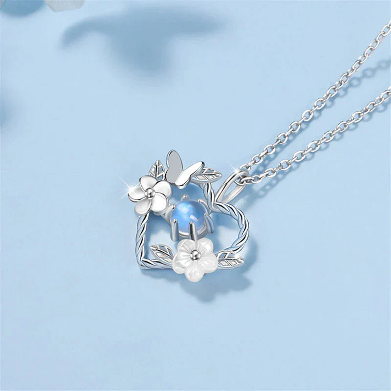 Close-up of a silver seashell flower heart pendant necklace with an adjustable chain, delicate ocean charm.