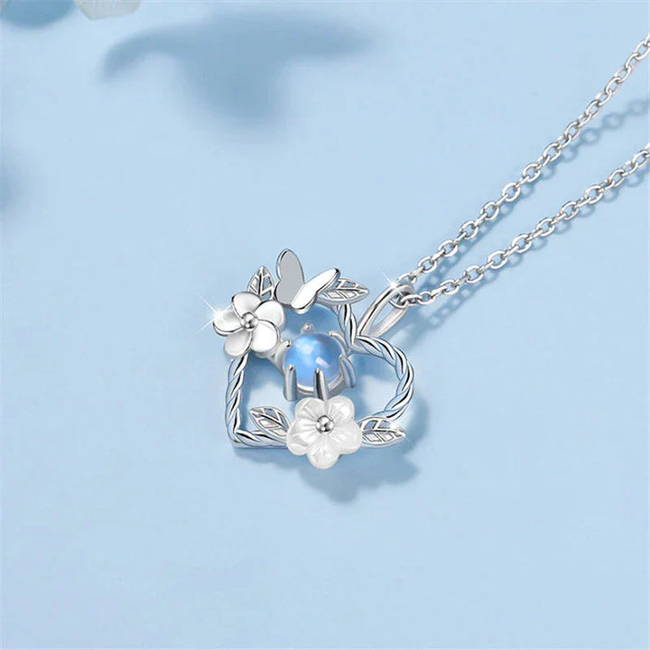 Close-up of a silver seashell flower heart pendant necklace with an adjustable chain, delicate ocean charm.