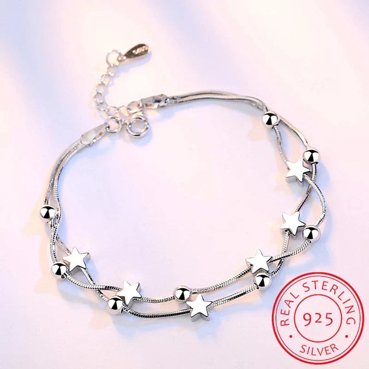 Delicate sterling silver adjustable bracelet for women featuring a minimalist star charm. Elegant everyday wear jewelry.