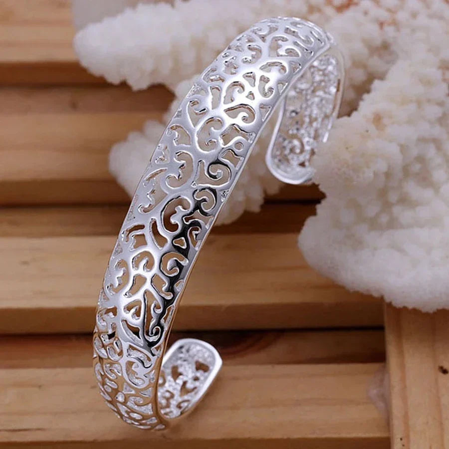 Woman's wrist adorned with a delicate sterling silver bracelet. Elegant and timeless fine jewelry for everyday wear.