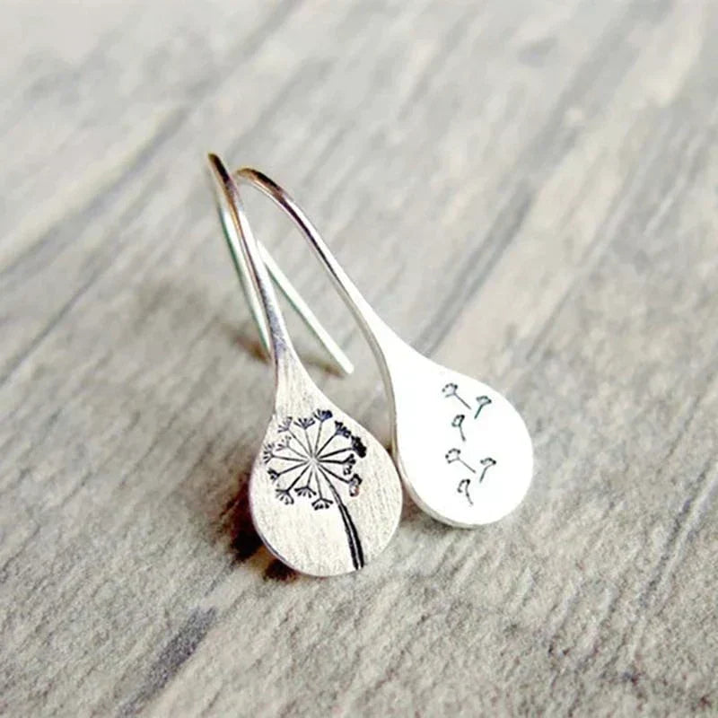 Symbolic sterling silver dandelion stud earrings, a delicate nature-inspired gift for her.