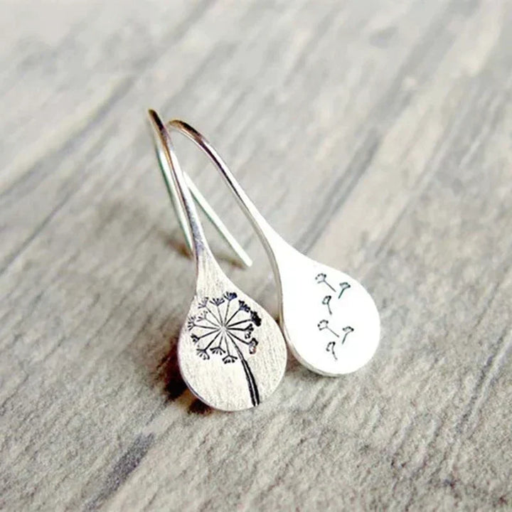 Symbolic sterling silver dandelion stud earrings, a delicate nature-inspired gift for her.