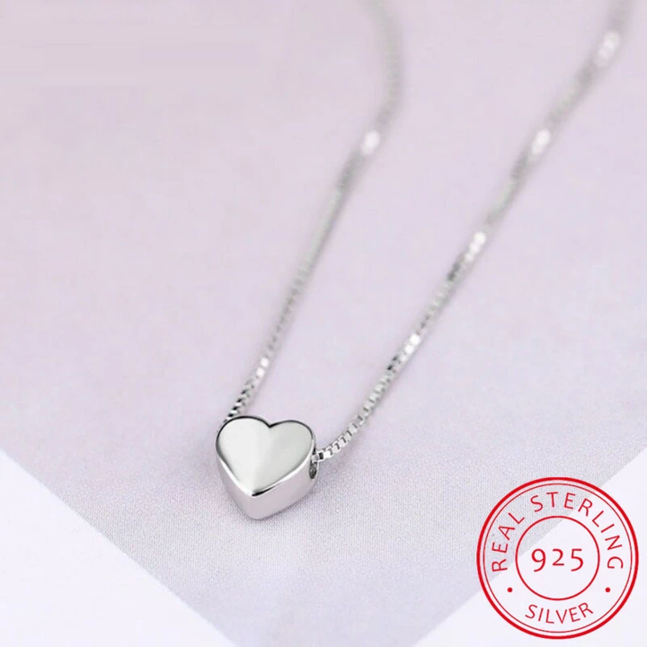 Elegant minimalist silver heart necklace, a perfect gift for her. Features a smooth, delicate design for timeless wear.