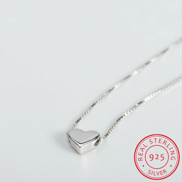 Minimalist smooth heart silver necklace for women. Delicate sterling silver, an elegant accessory, makes a timeless gift.