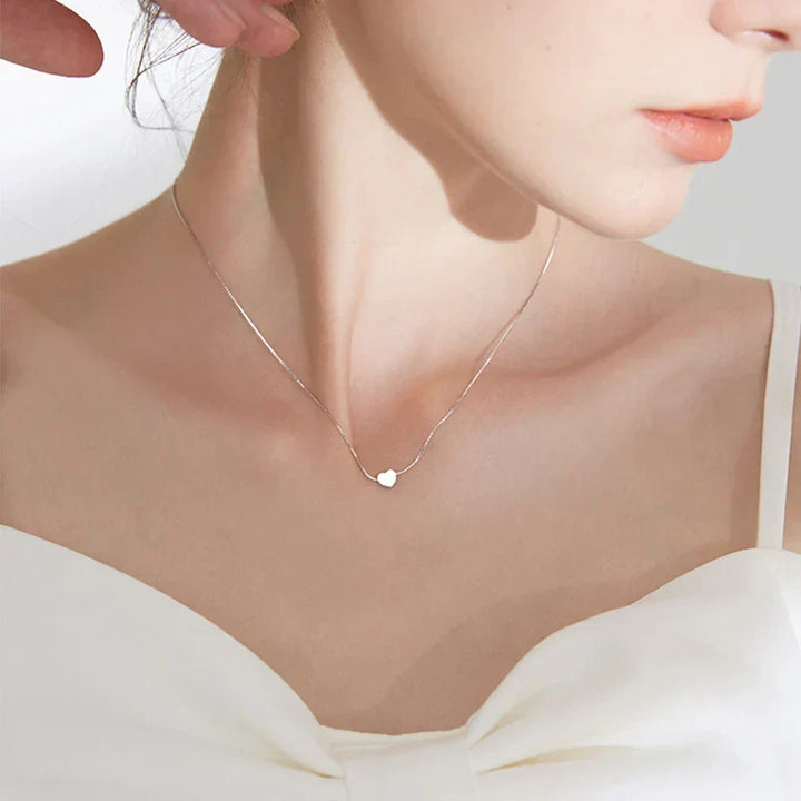 Graceful smooth heart necklace in sterling silver, a minimalist jewelry piece for women. Delicate and elegant accessory.