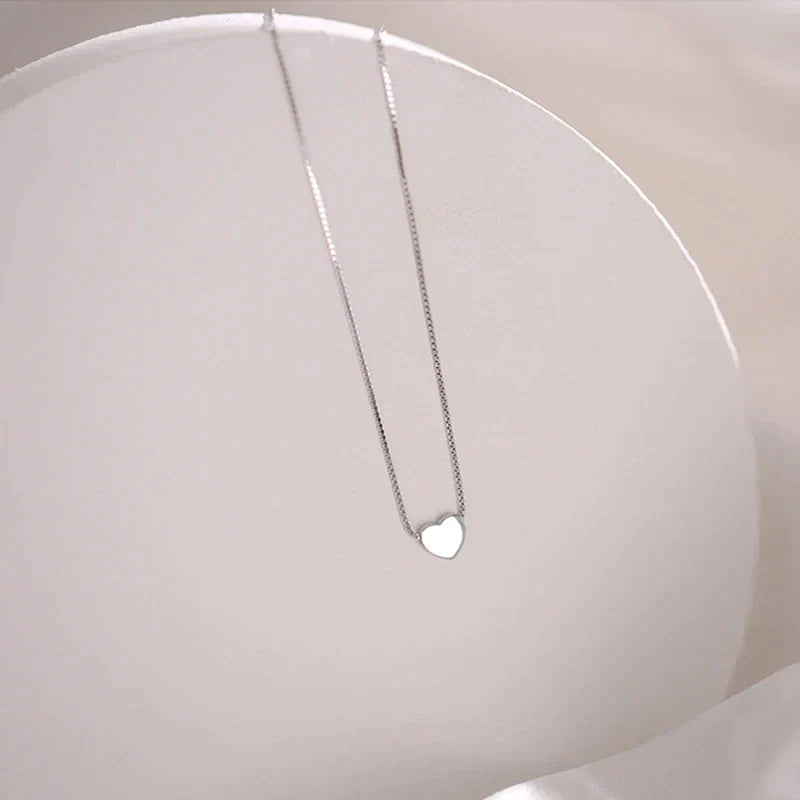 Elegant silver minimalist heart necklace, a delicate sterling silver accessory for women. Perfect timeless jewelry gift.