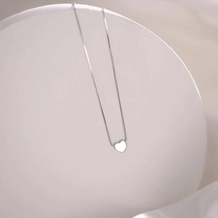 Elegant silver minimalist heart necklace, a delicate sterling silver accessory for women. Perfect timeless jewelry gift.
