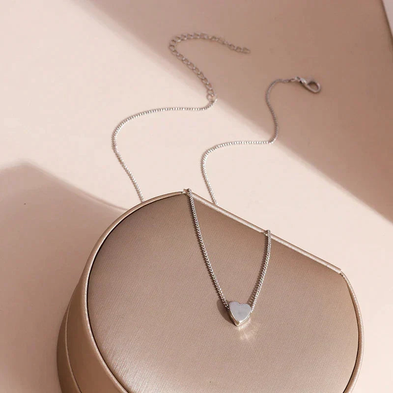 Pure sterling silver minimalist smooth heart necklace. Delicate, elegant womens jewelry, a timeless accessory for her.