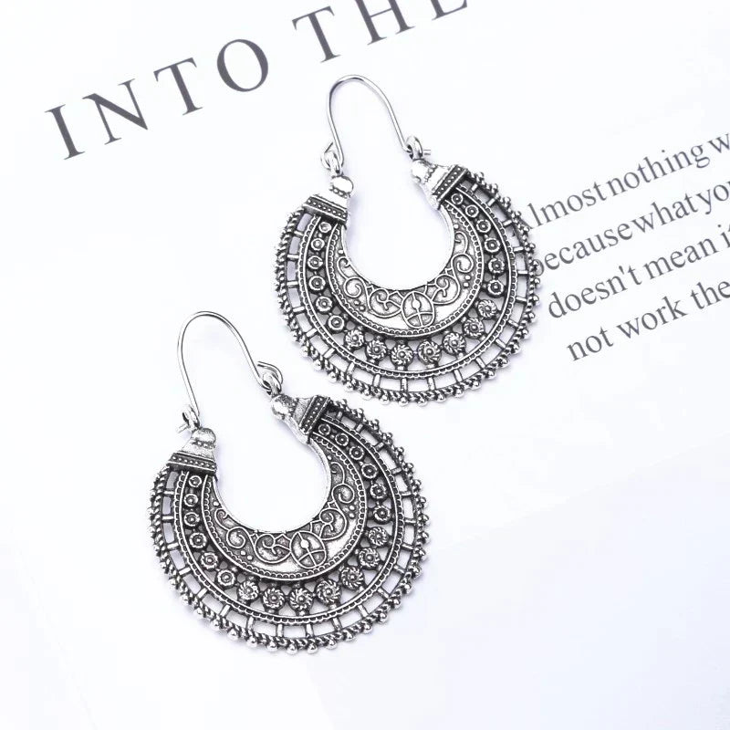 Intricate filigree detail on delicate Tibetan 925 sterling silver hook earrings, elegant women's accessory.