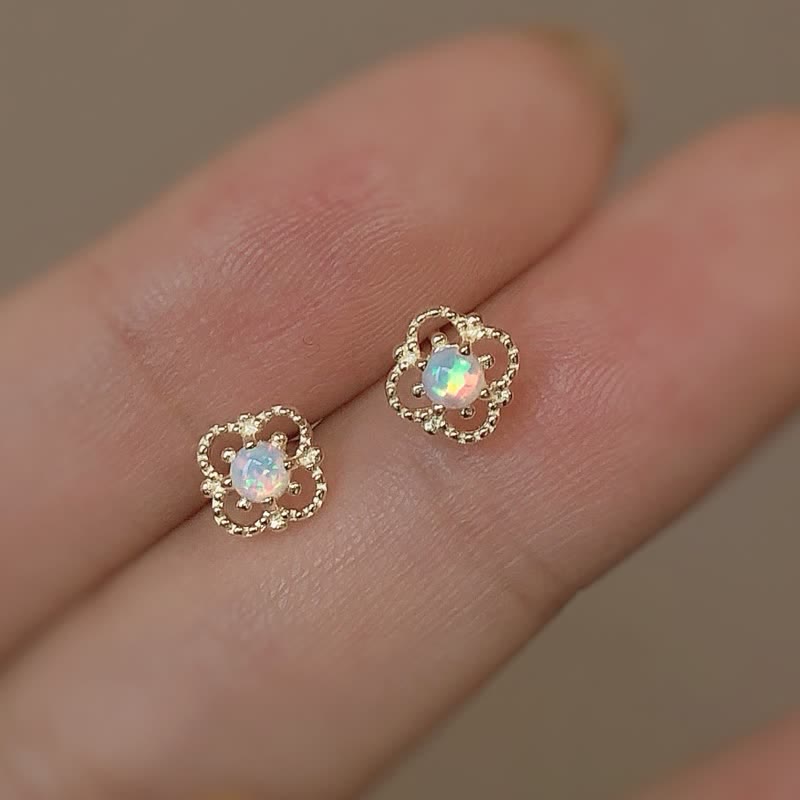Close-up: Women's delicate vintage opal drop earring, showcasing intricate detail.