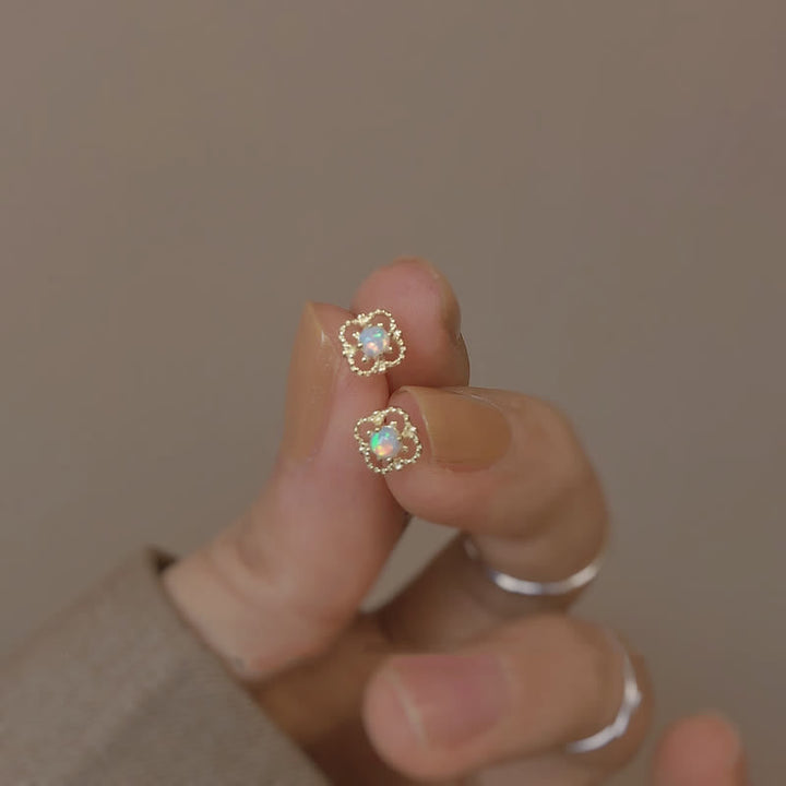 Women's elegant vintage opal drop earrings worn by model, enhancing a stylish look.