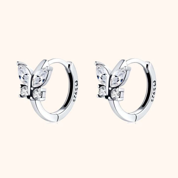 Delicate women's crystal butterfly hoop earrings in silver & gold. Elegant sterling silver, gold-plated jewelry.