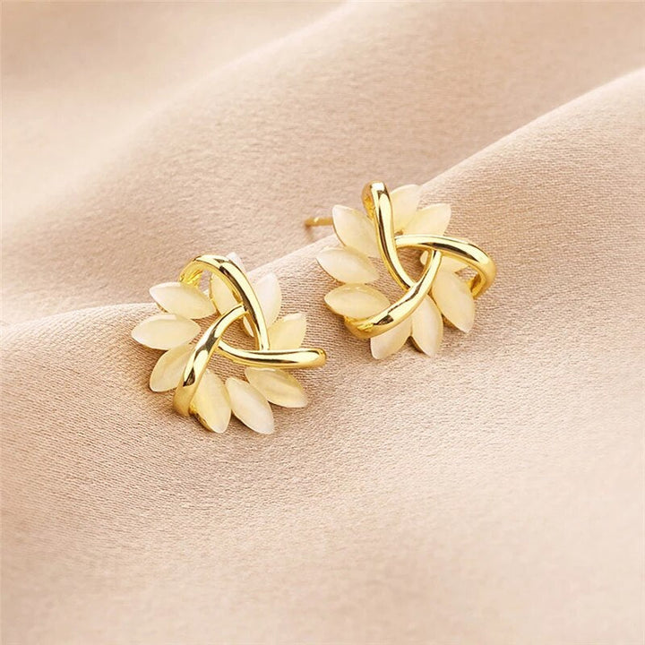 Close-up of sparkling women's opal petal drop earrings. Delicate, nature-inspired jewelry for elegant fashion.