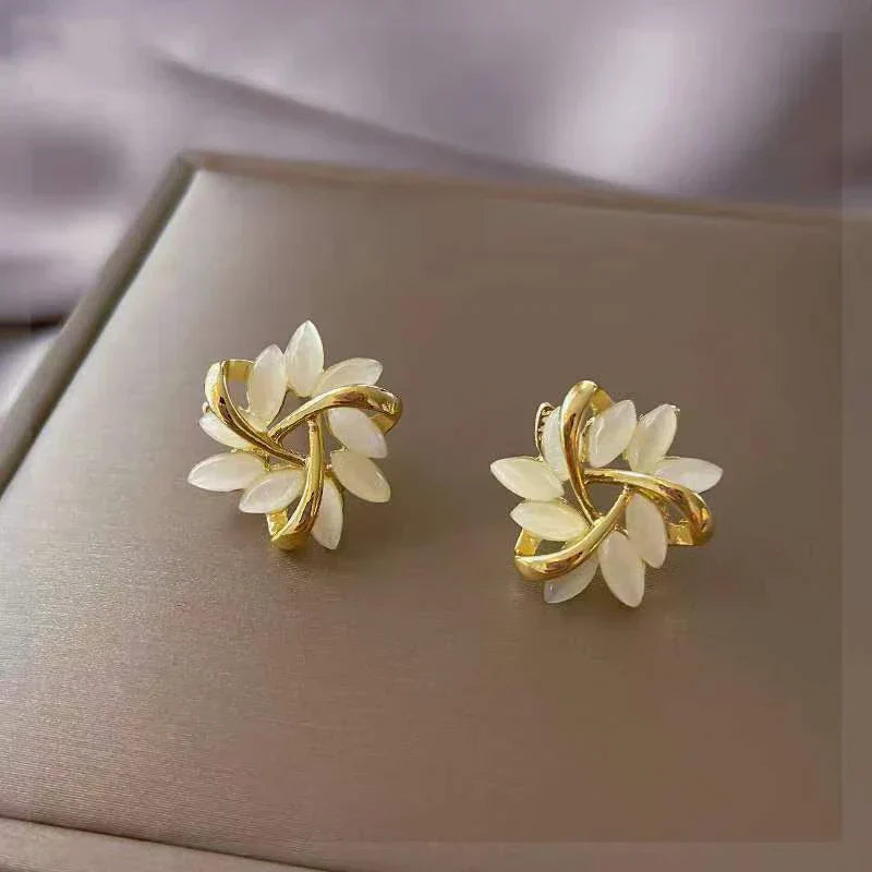 Stunning women's delicate opal petal drop earrings. Elegant, nature-inspired fashion jewelry, a perfect gift for her.