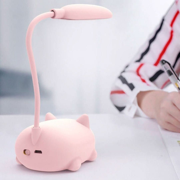 Close-up of Deskpurr USB cat lamp, showing soft LED light and cute cat ear design, portable light.