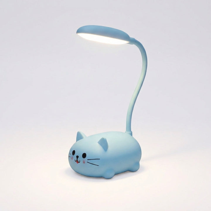Small Deskpurr cat desk lamp illuminating a book, demonstrating its use as a study light.
