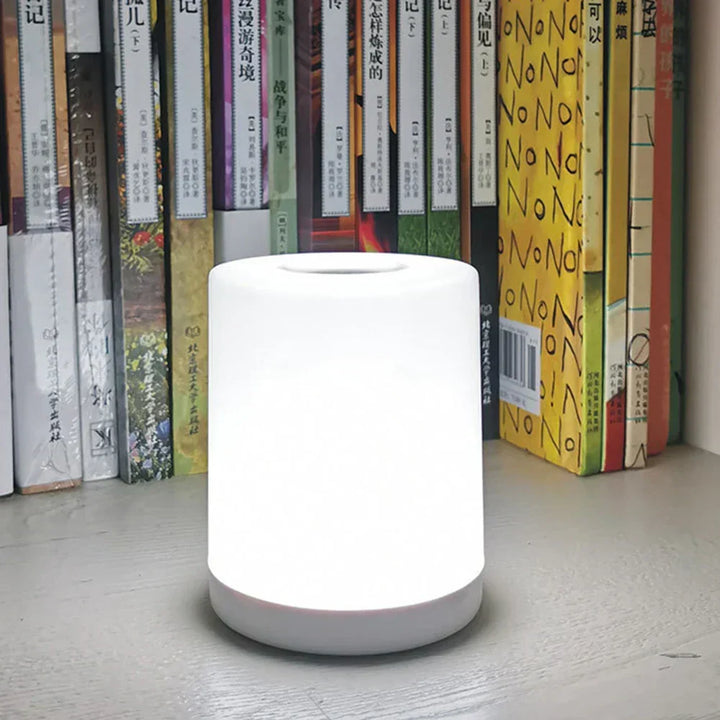 Dimmable LED desk lamp with USB charging port. Modern design for home office, study, or bedside.
