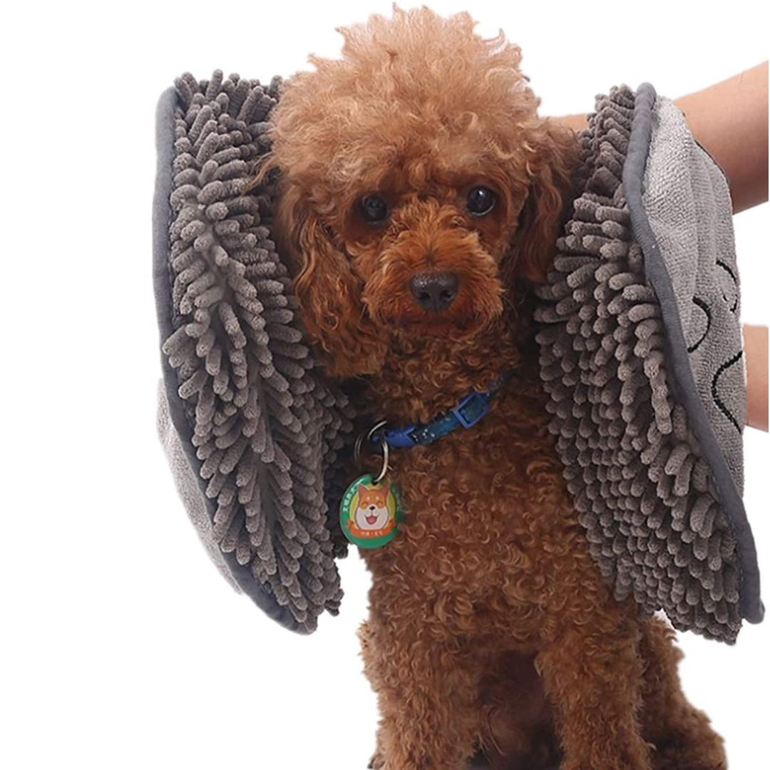 Owner gently drying dog with an ultra-absorbent microfiber towel, showcasing pet care.