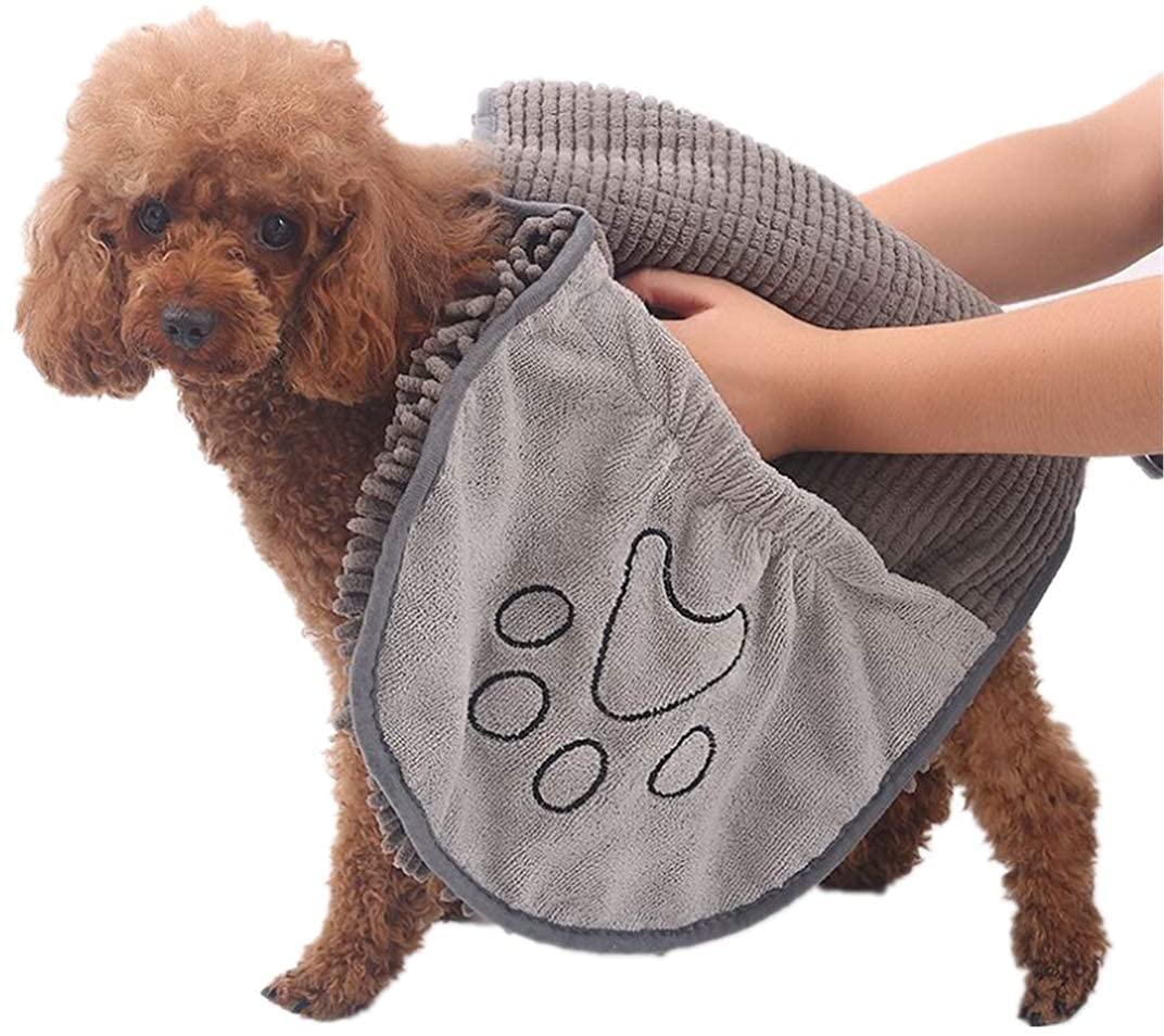 Wet dog standing on a large microfiber drying towel, showing its ultra-absorbent power.