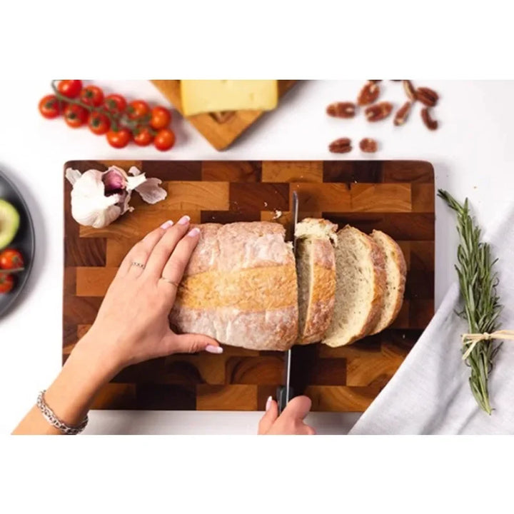 Elegant acacia wood cutting board, double-sided with clever drainage for mess-free and efficient food preparation.