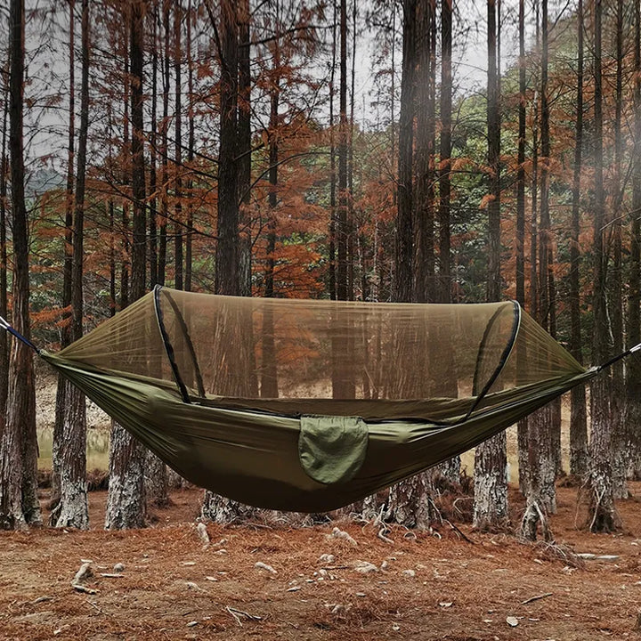 Durable camping hammock with integrated mosquito net for outdoor relaxation & bug protection.