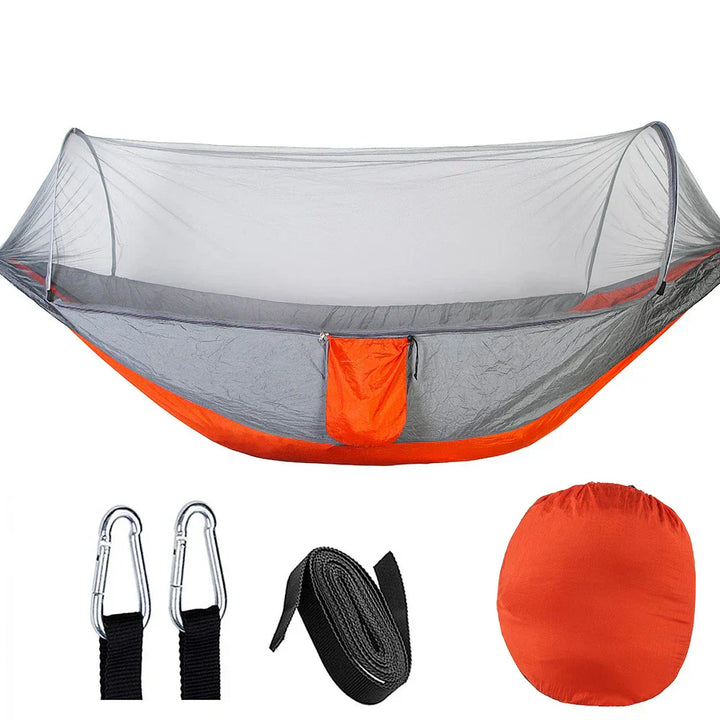 Durable parachute hammock with an integrated mosquito bug net for ultimate outdoor comfort.
