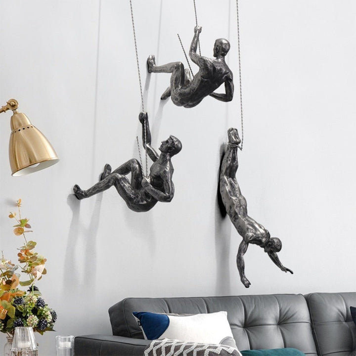 Abstract climbing figure wall sculpture, unique artistic interior design.