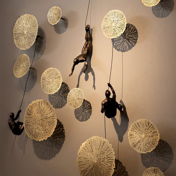 Artistic handmade wall accent, a dynamic climbing figure sculpture.