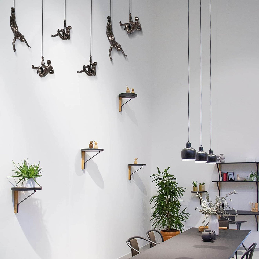 Hand-crafted dynamic climber figure for contemporary home wall decor.