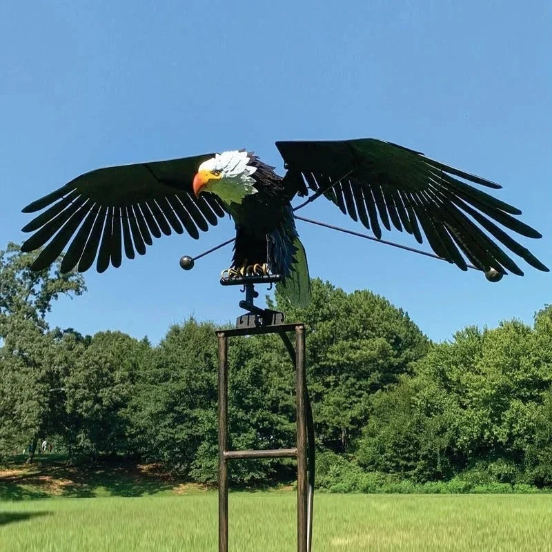 Dynamic metal wind spinner with majestic bird & owl garden art. Outdoor patio decor.