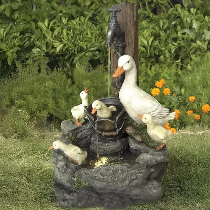 Decorative outdoor solar fountain with integrated LED light, featuring a charming wildlife design. Perfect garden water feature.