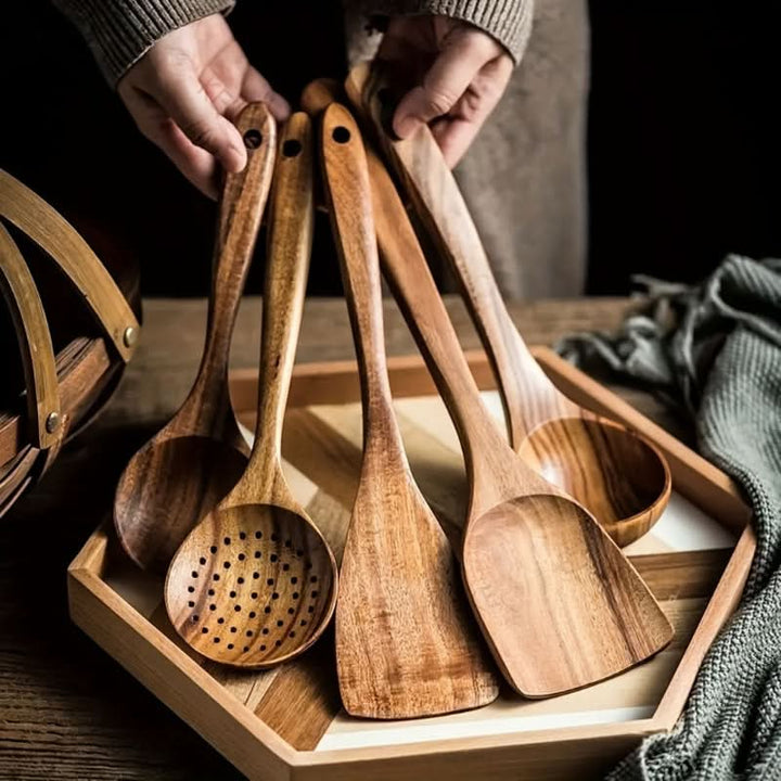 Eco-friendly teak wood kitchen utensil set for stylish cooking. Sustainable, natural wooden spatulas & serving spoons.