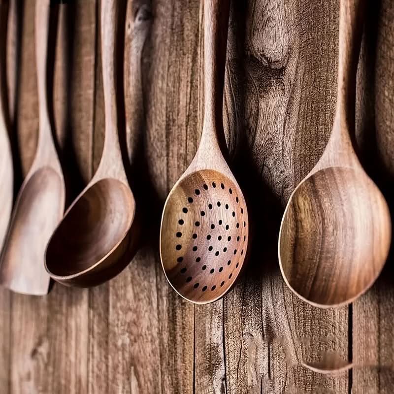 Stylish eco-friendly teak wood kitchenware set. Sustainable natural cooking tools, spatulas, and serving utensils.