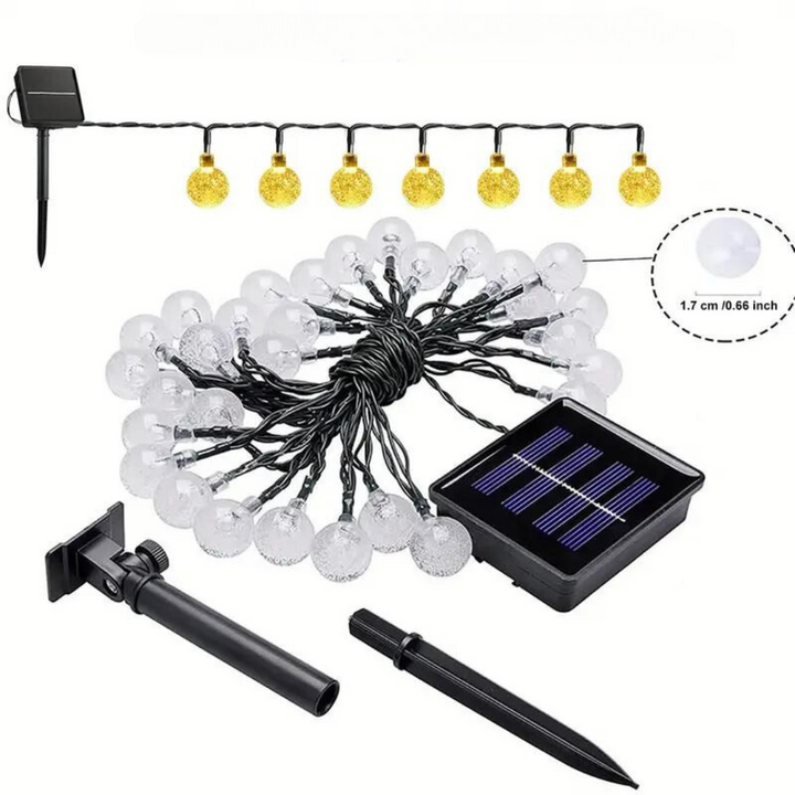 Eco-friendly solar string lights draped over a tent at a campsite, providing warm ambient lighting for outdoor use.