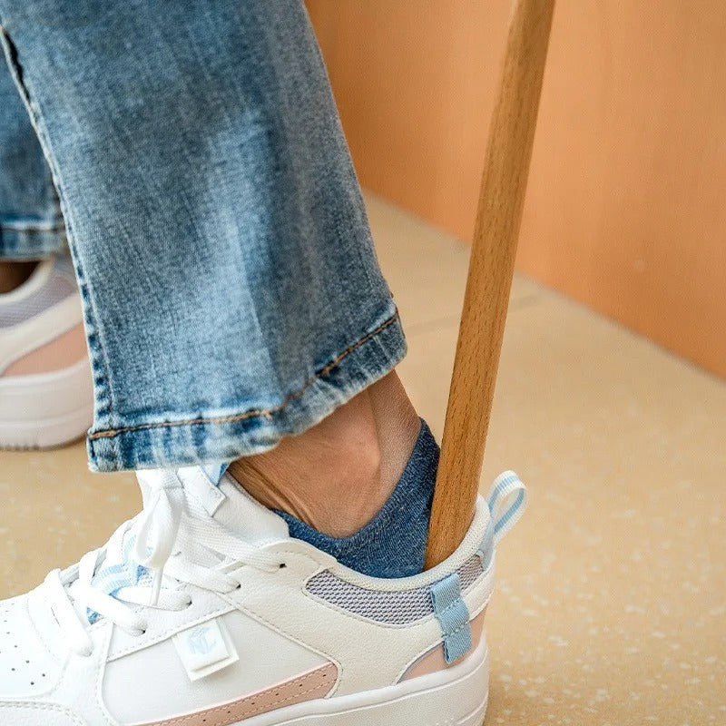 Premium long wood shoehorn with magnetic wall storage. Elegant beechwood accessory for easy shoe donning.