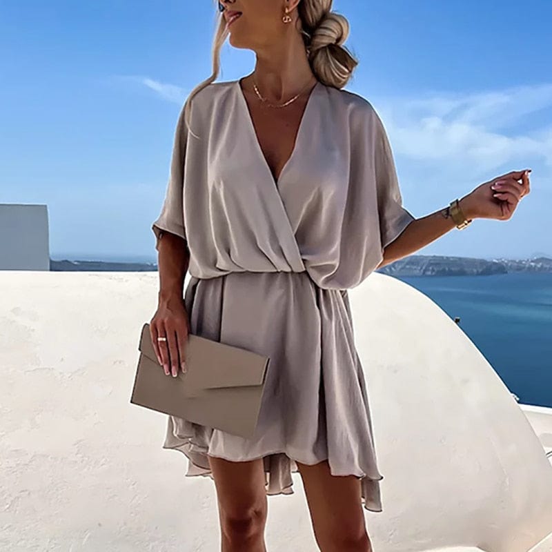 Effortless women's flowy bohemian mini dress with V-neck & short sleeves, perfect for summer beach or casual wear.